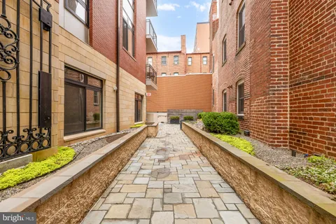 a view of a pathway both side of house