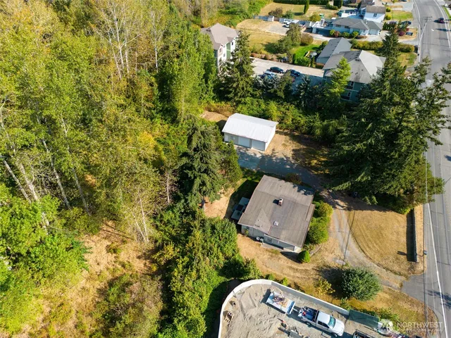 an aerial view of a house with a yard and trees