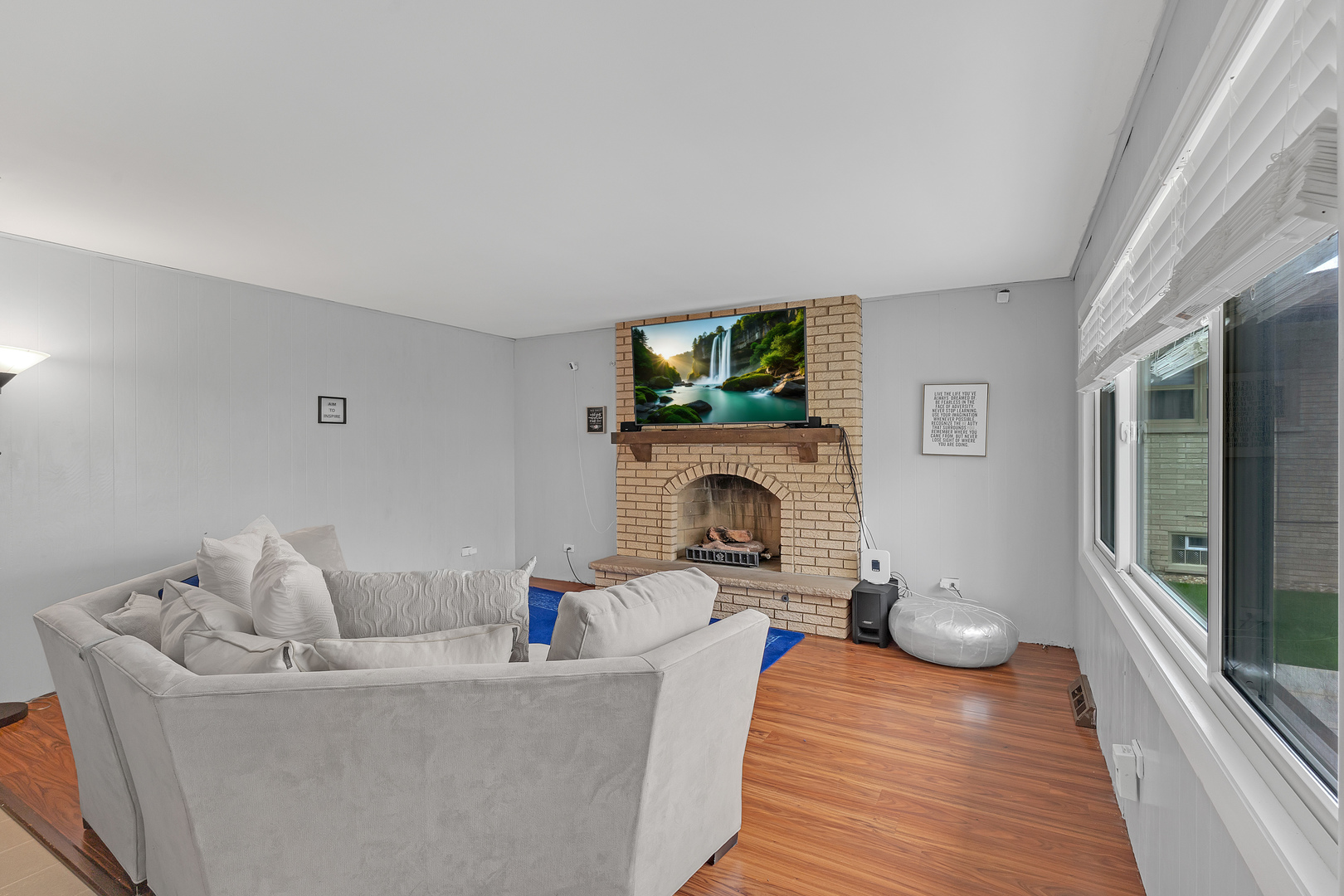 11020 Raleigh Street Westchester, IL 60154 - Photo 12 of 27 a living room with furniture a flat screen tv and a fireplace