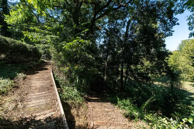 a backyard of a house with outdoor seating and trees