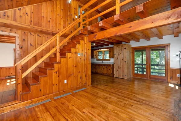 a view of a room with wooden floors