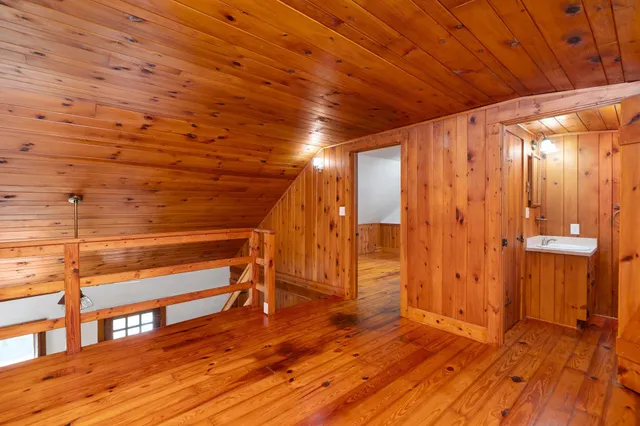 a view of a room with wooden floors