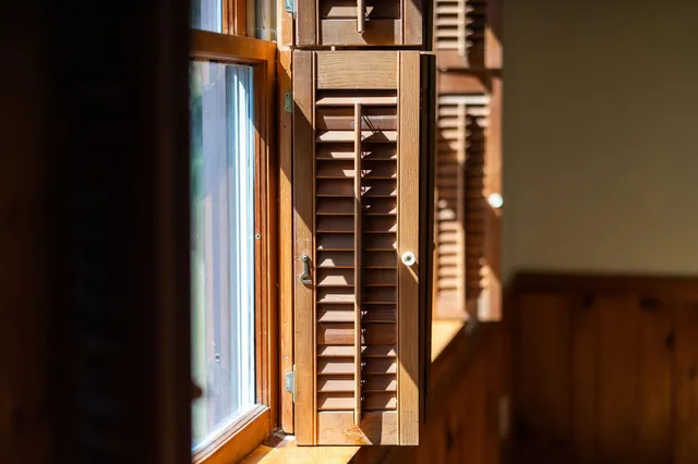 a view of empty room with wooden floor and windows