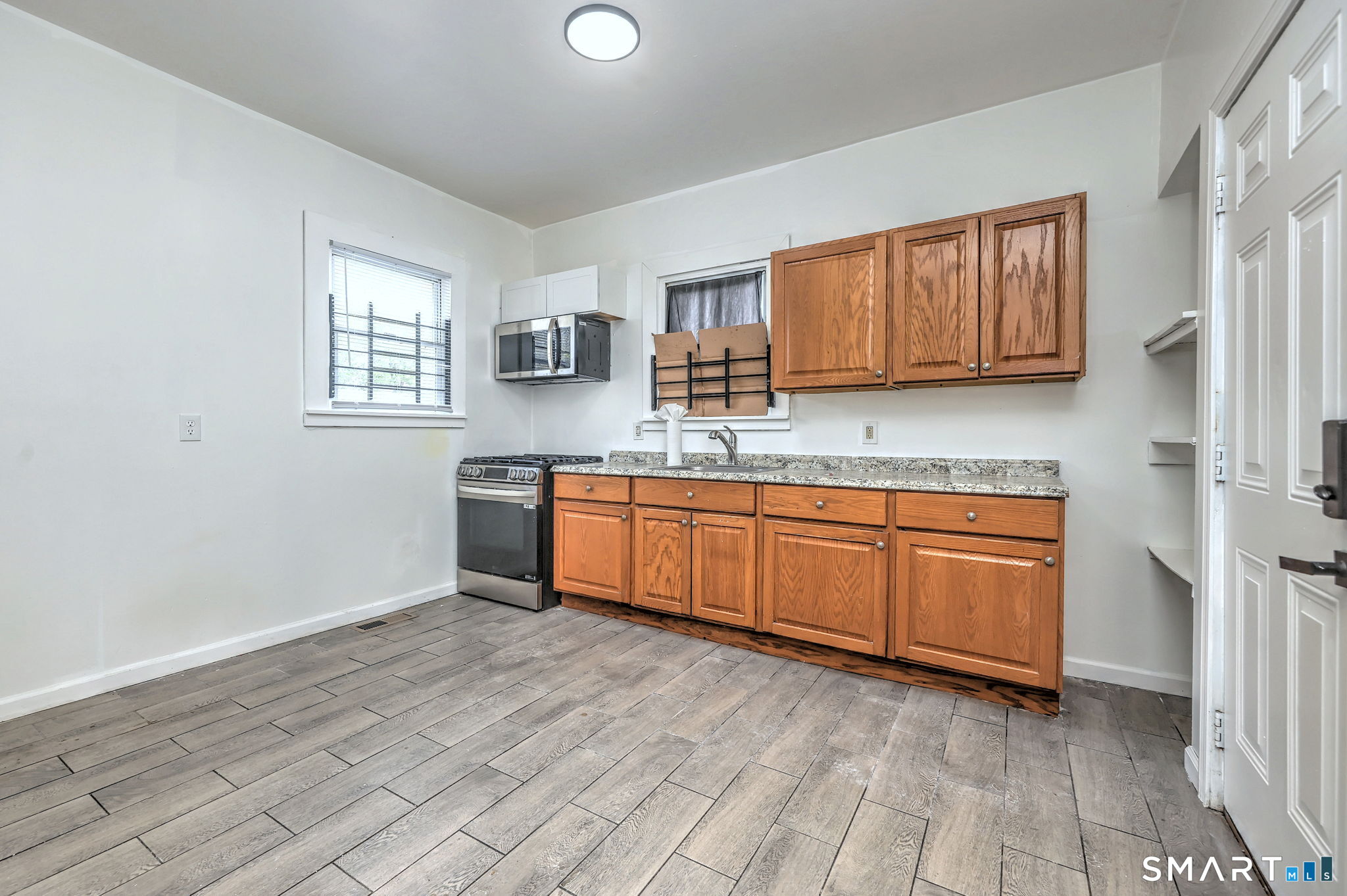 483 Ferry Street, Unit 1 New Haven, CT 06513 - Photo 15 of 33 a kitchen with granite countertop a sink cabinets and wooden floor