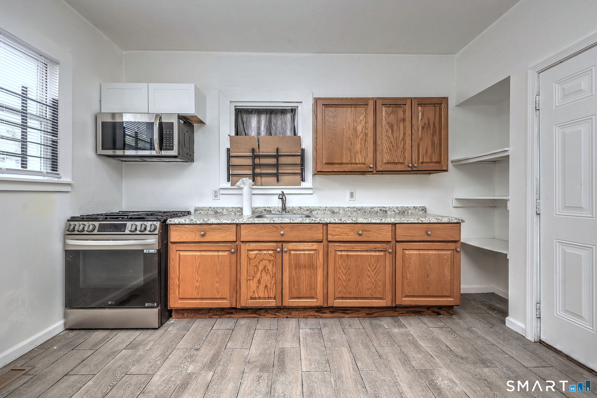 483 Ferry Street, Unit 1 New Haven, CT 06513 - Photo 16 of 33 a kitchen with stainless steel appliances granite countertop a stove a sink and a microwave
