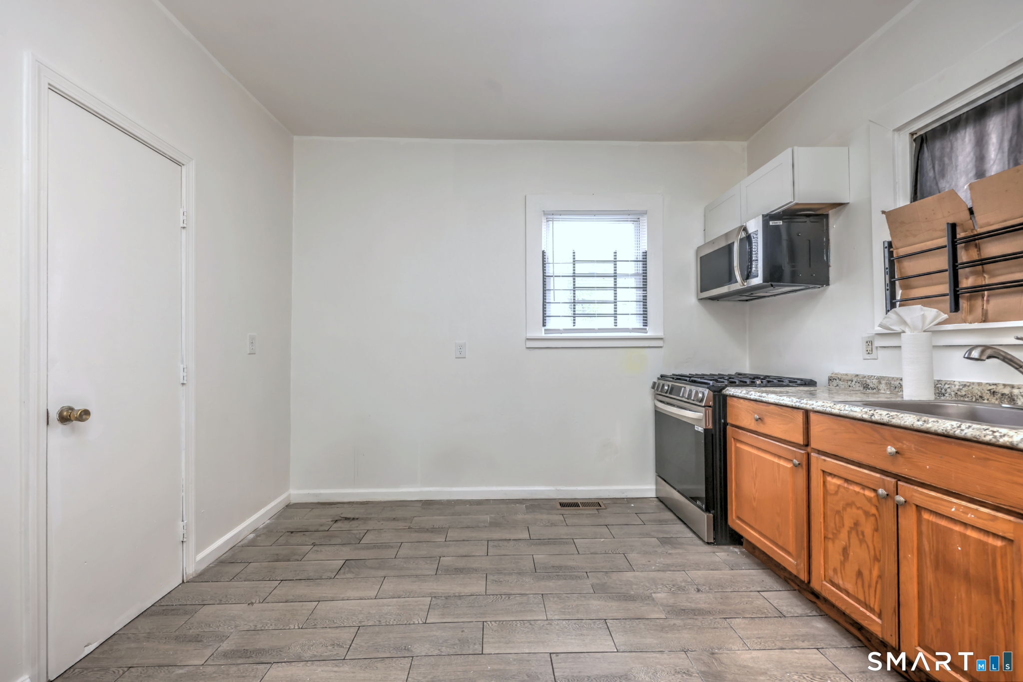 483 Ferry Street, Unit 1 New Haven, CT 06513 - Photo 19 of 33 a kitchen with stainless steel appliances granite countertop a sink and a stove top oven