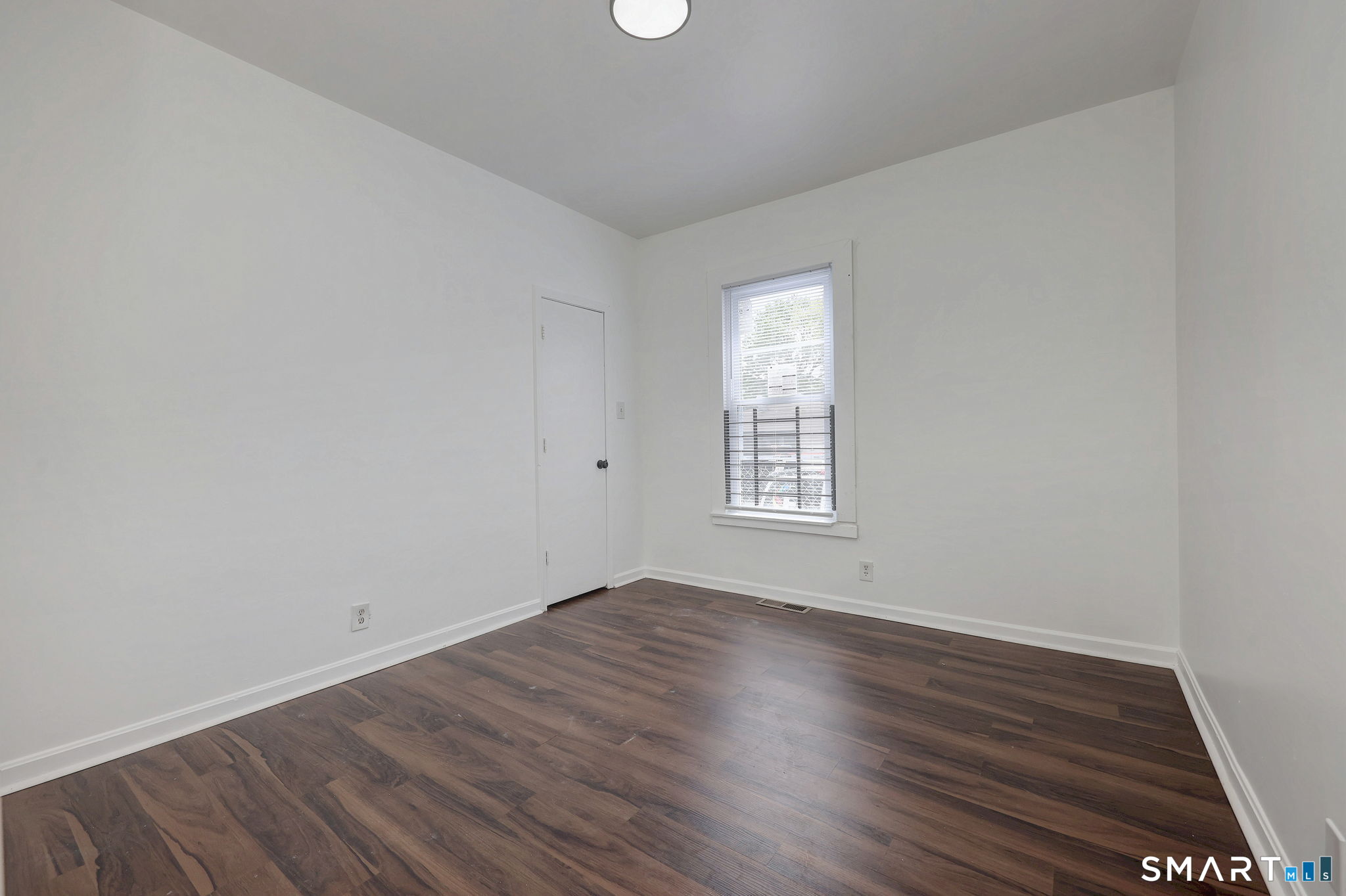 483 Ferry Street, Unit 1 New Haven, CT 06513 - Photo 21 of 33 an empty room with wooden floor and windows