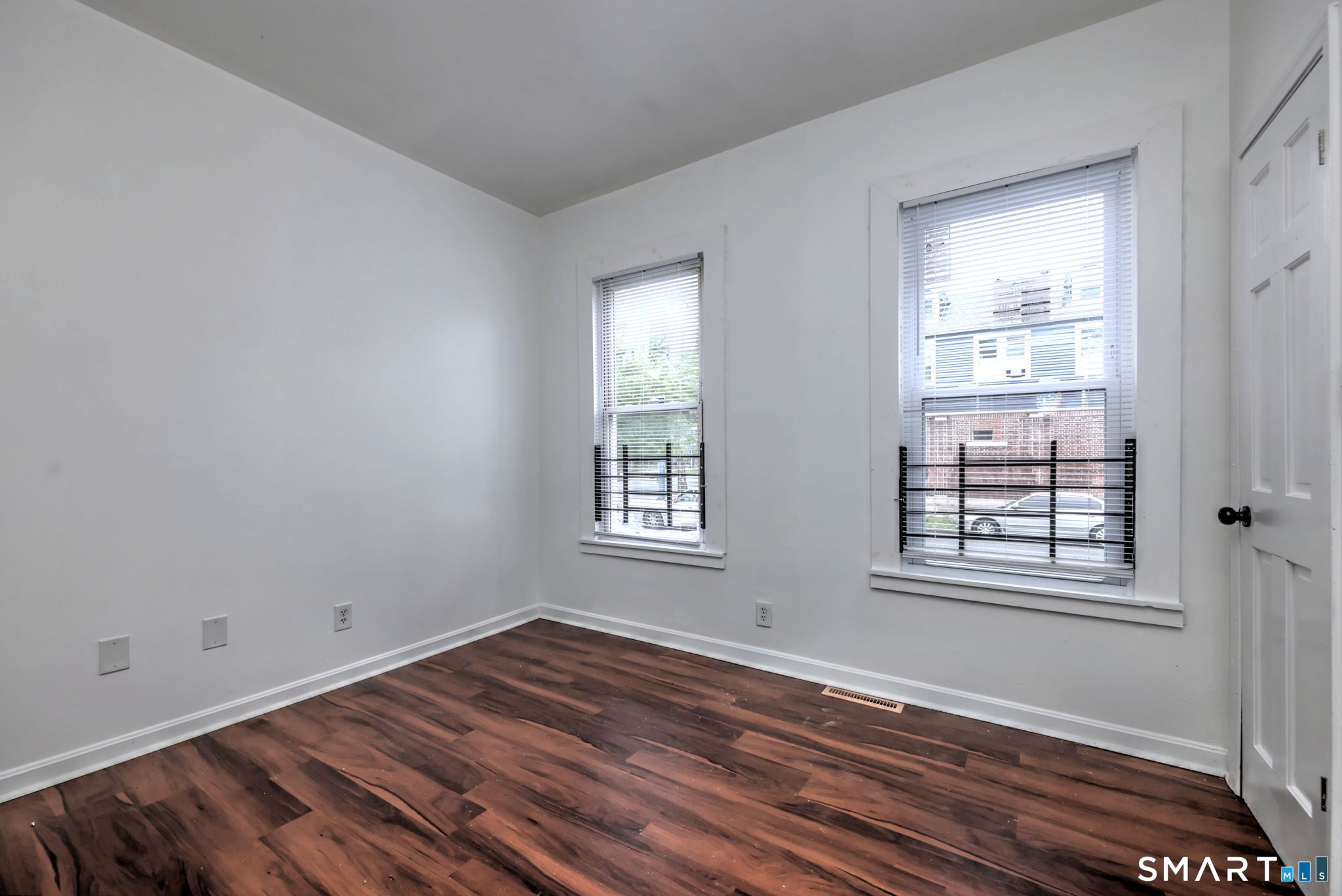 483 Ferry Street, Unit 1 New Haven, CT 06513 - Photo 26 of 33 a view of an empty room with wooden floor and a window