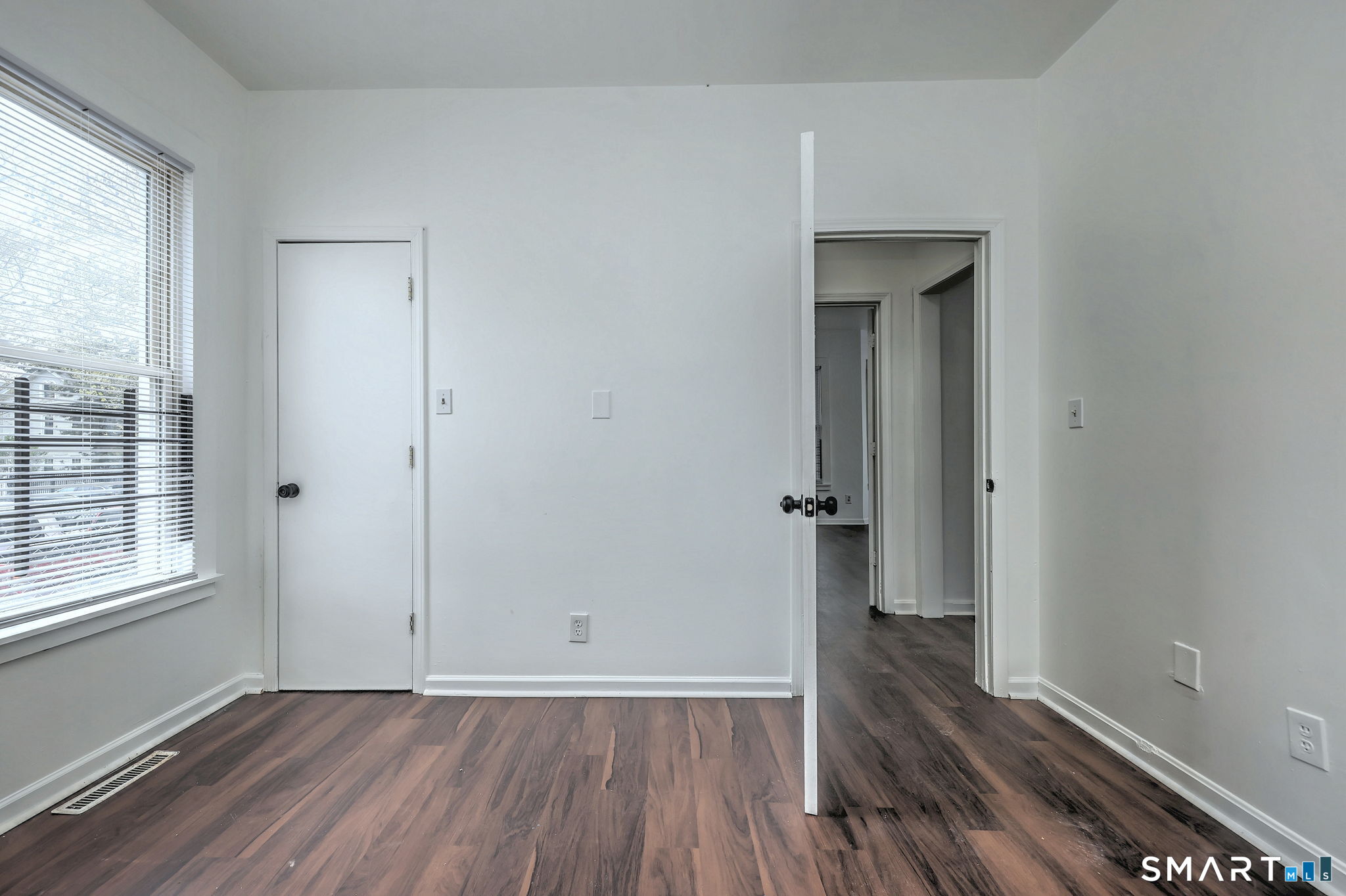483 Ferry Street, Unit 1 New Haven, CT 06513 - Photo 29 of 33 an empty room with wooden floor and windows