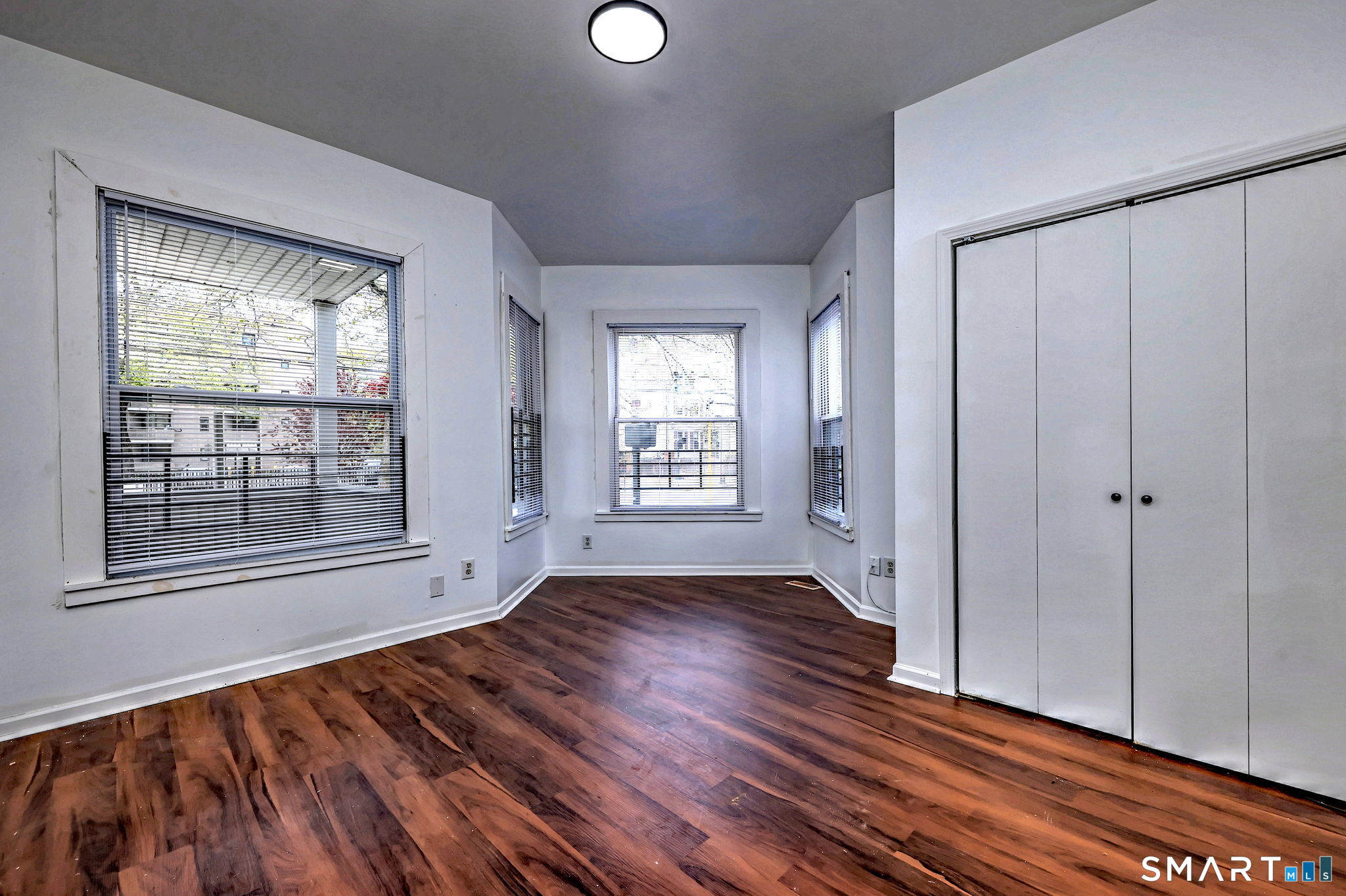 483 Ferry Street, Unit 1 New Haven, CT 06513 - Photo 8 of 33 a view of an empty room with wooden floor and a window