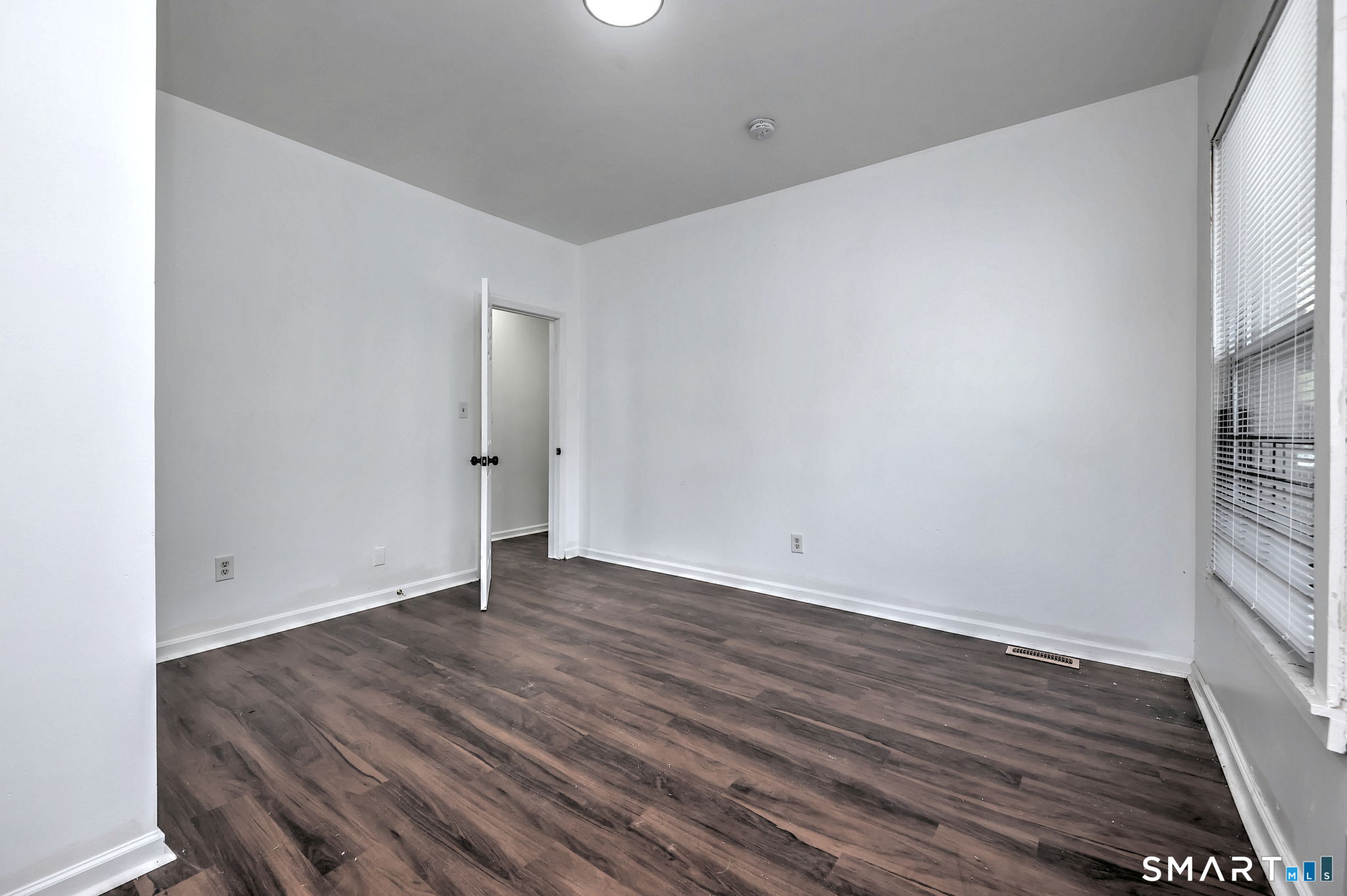 483 Ferry Street, Unit 1 New Haven, CT 06513 - Photo 10 of 33 a view of an empty room with wooden floor and a window