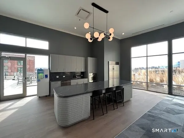 a living room with kitchen island furniture and a large window