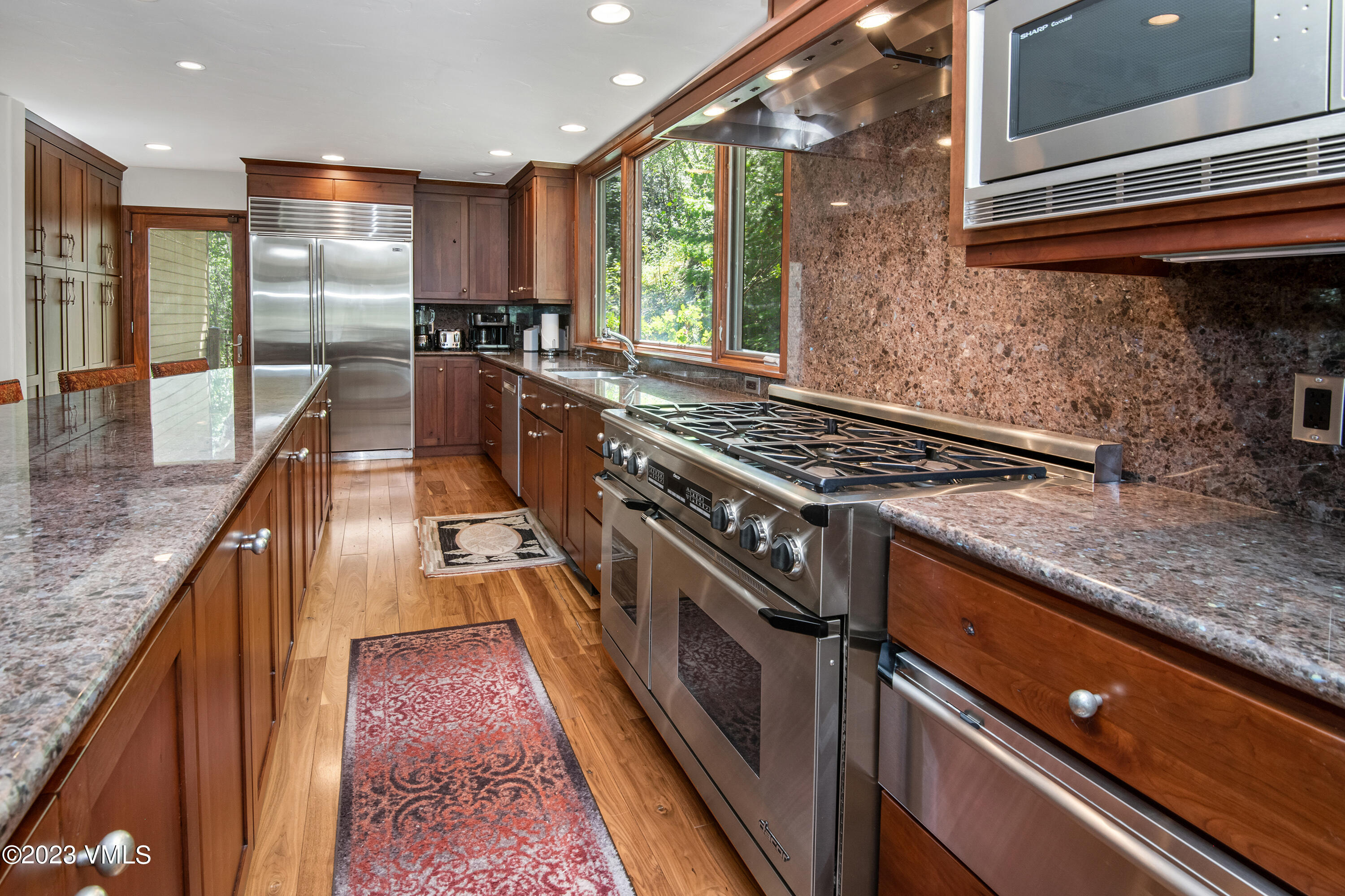 850 Eagle Drive Eagle-Vail, CO 81620 - Photo 4 of 11 a kitchen with stainless steel appliances granite countertop a stove a sink and a microwave