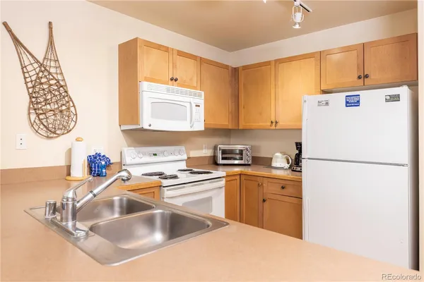 a kitchen with a sink cabinets and refrigerator