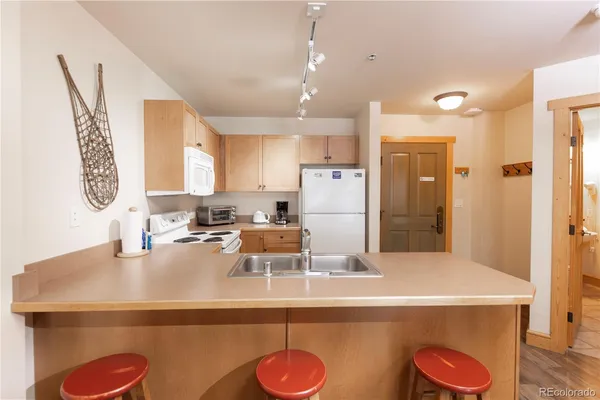 a kitchen with refrigerator and sink
