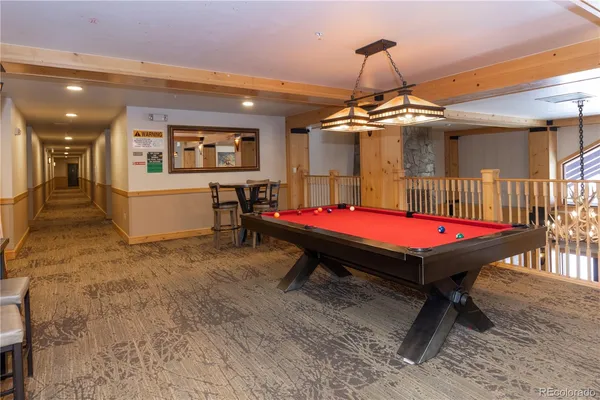 a room with pool table and flat screen tv