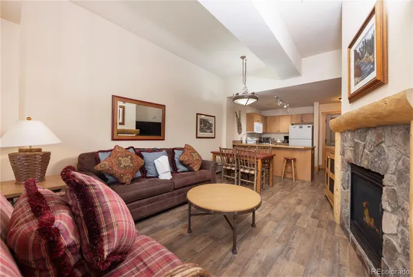 a living room with furniture a fireplace and a table