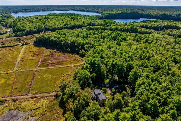 an aerial view of a houses with a lake view