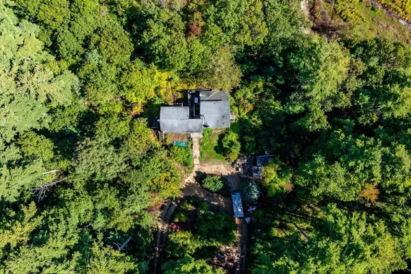 an aerial view of a house with yard and outdoor seating