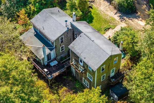 view of a house with a yard and sitting area