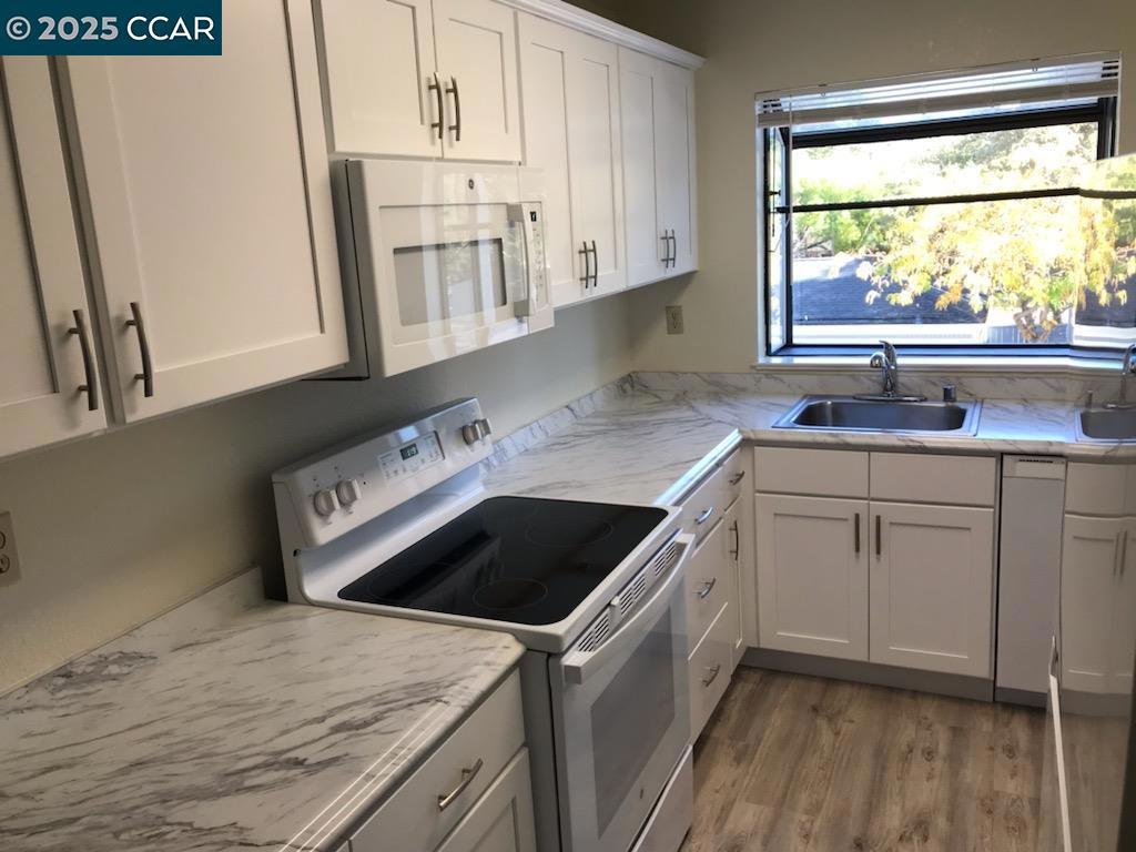 1300 Walden Road Walnut Creek, CA 94597 - Photo 11 of 52 a kitchen with a sink window and cabinets