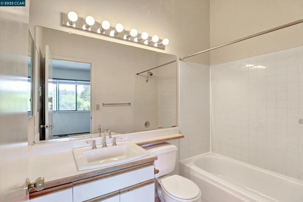 1300 Walden Road Walnut Creek, CA 94597 - Photo 37 of 52 a bathroom with a granite countertop sink toilet a large mirror and shower