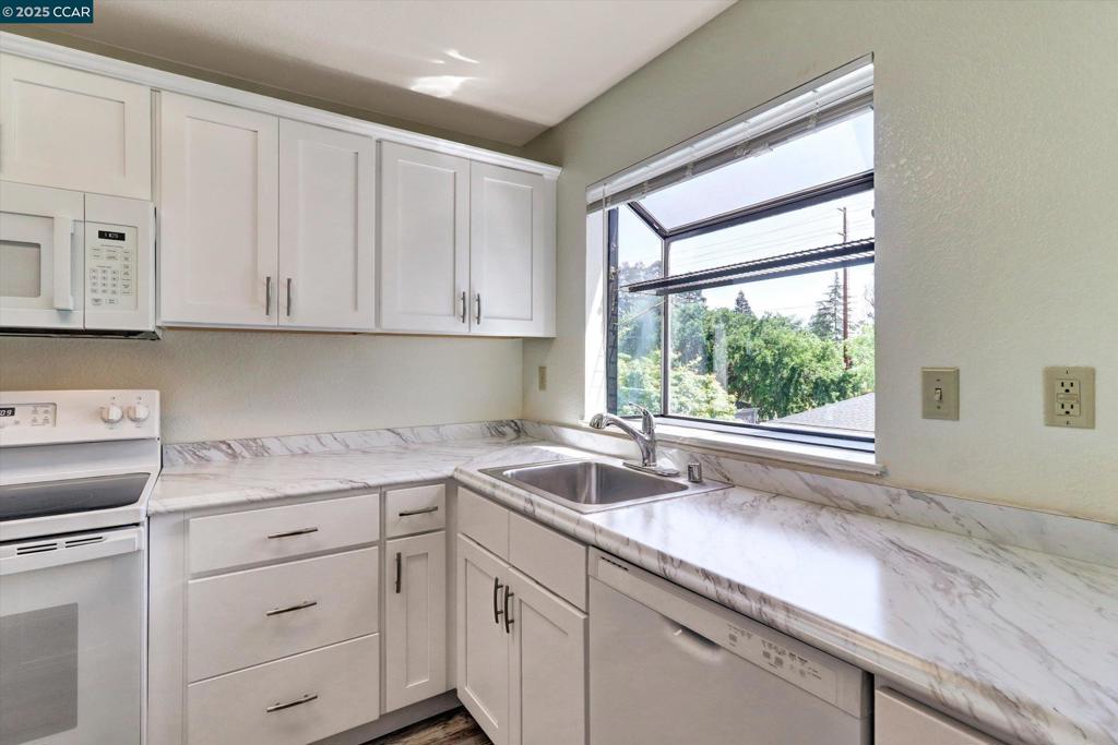 1300 Walden Road Walnut Creek, CA 94597 - Photo 5 of 52 a kitchen with granite countertop a sink window and cabinets