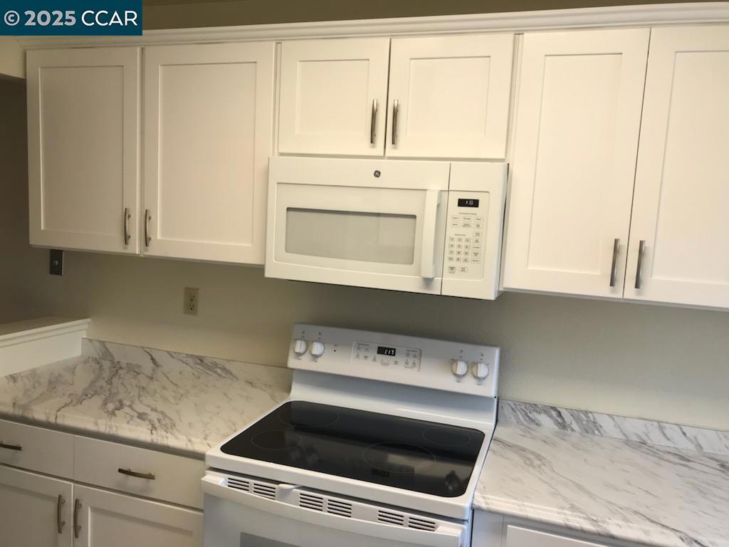 1300 Walden Road Walnut Creek, CA 94597 - Photo 10 of 52 a stove top oven sitting inside of a kitchen