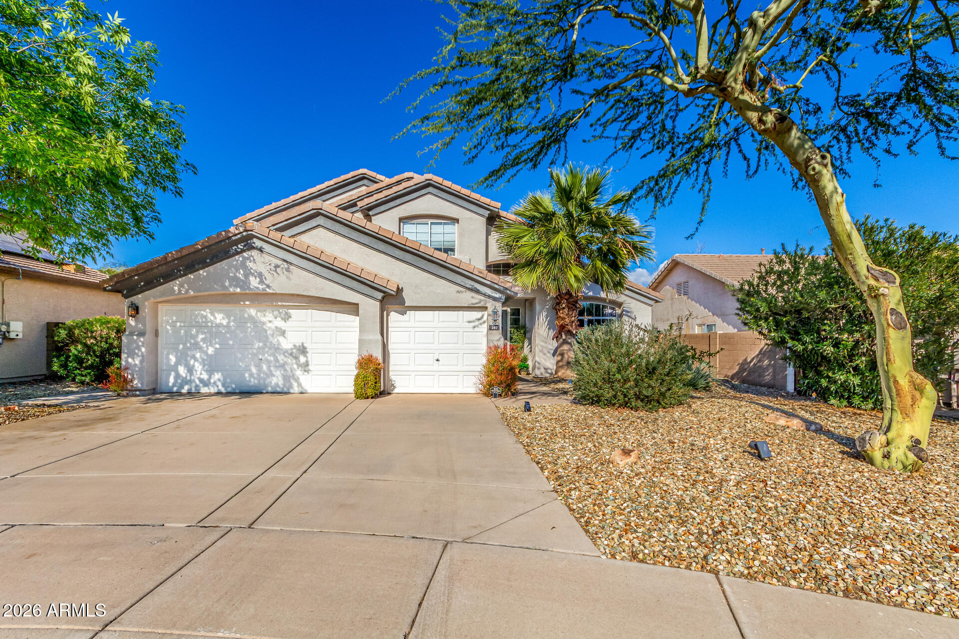 a view of a house with a small yard and potted plants