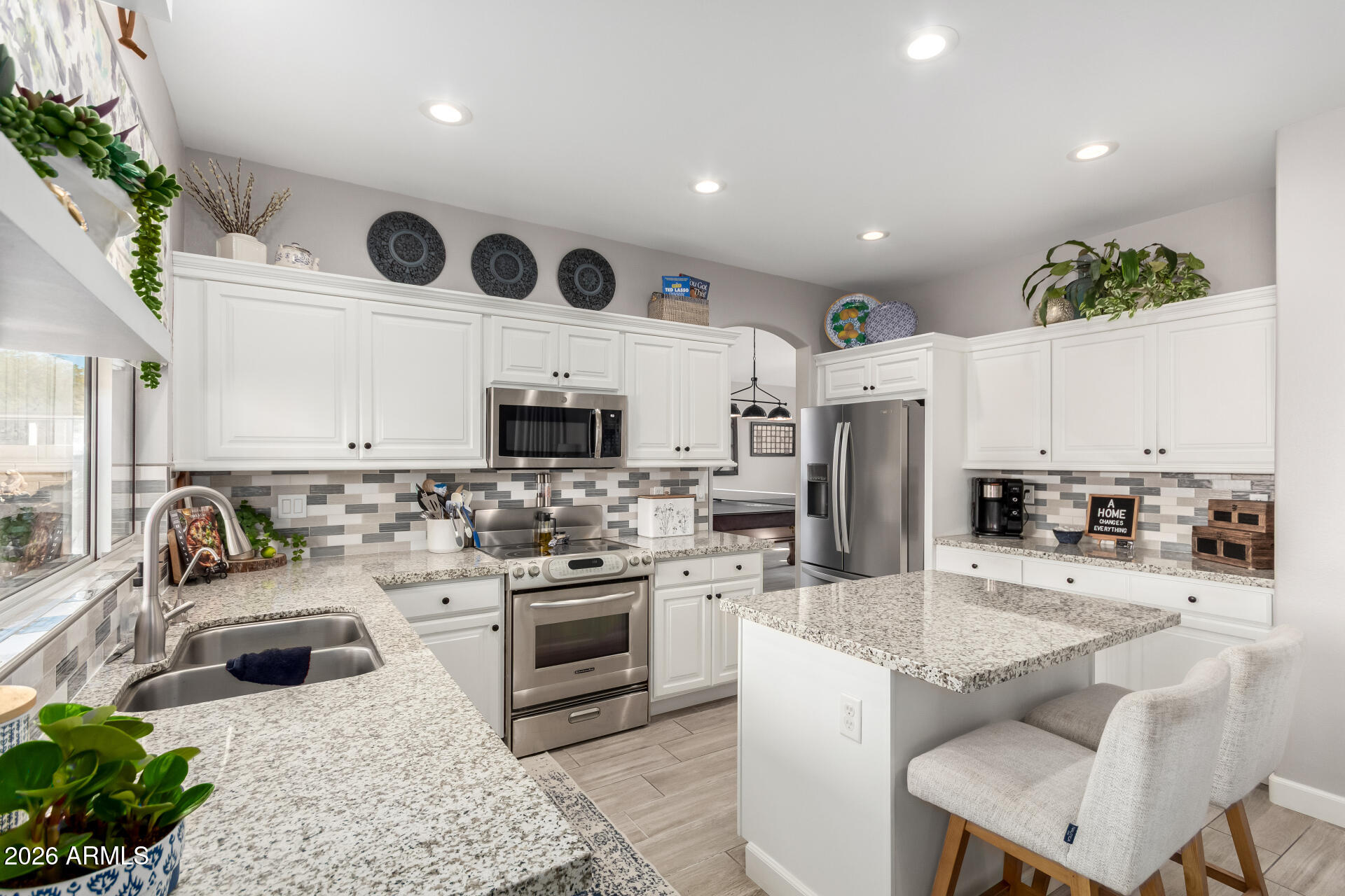 240 East Gail Court Gilbert, AZ 85296 - Photo 11 of 49 a kitchen with stainless steel appliances kitchen island granite countertop a sink and stove top oven