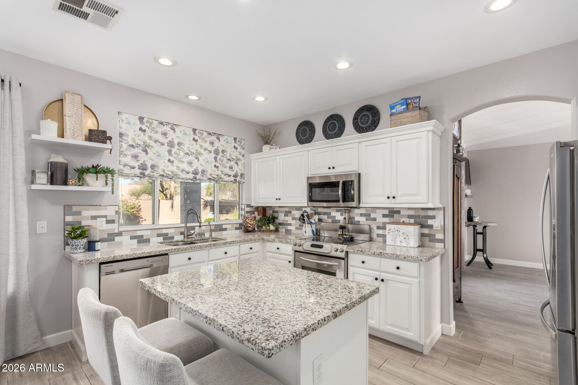 240 East Gail Court Gilbert, AZ 85296 - Photo 13 of 49 a kitchen with stainless steel appliances kitchen island granite countertop a sink and cabinets