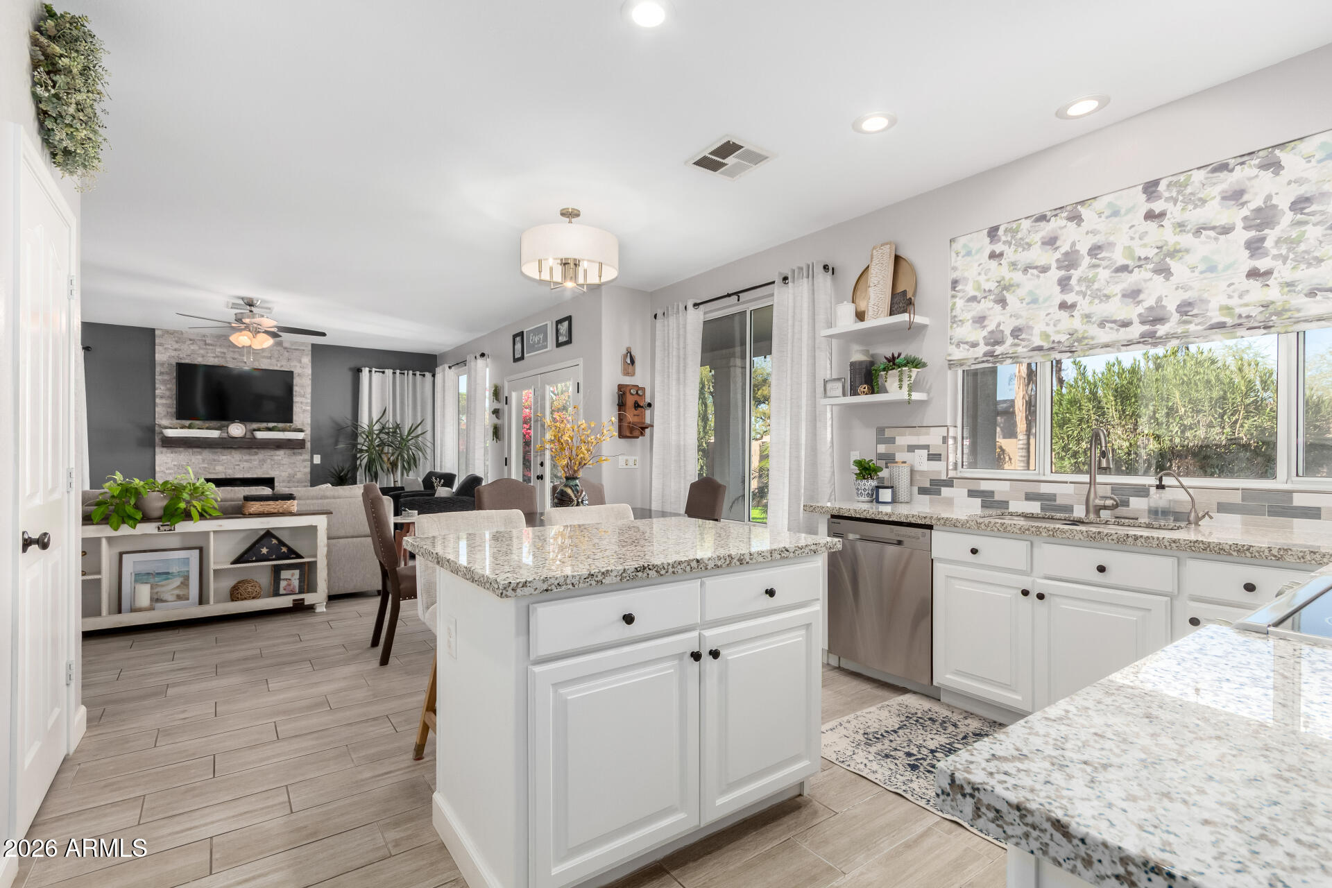 240 East Gail Court Gilbert, AZ 85296 - Photo 14 of 49 a kitchen with stainless steel appliances kitchen island granite countertop a sink and cabinets