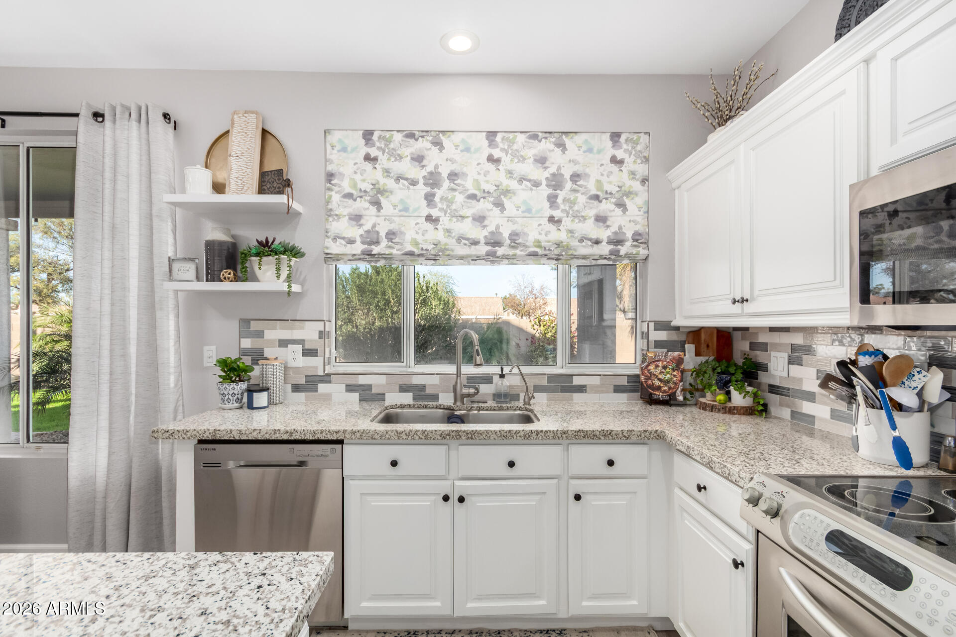 240 East Gail Court Gilbert, AZ 85296 - Photo 15 of 49 a kitchen with stainless steel appliances white cabinets and a window
