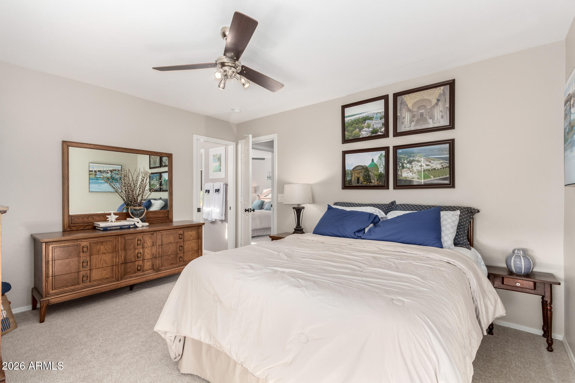 240 East Gail Court Gilbert, AZ 85296 - Photo 30 of 49 a bedroom with a large bed and a chandelier