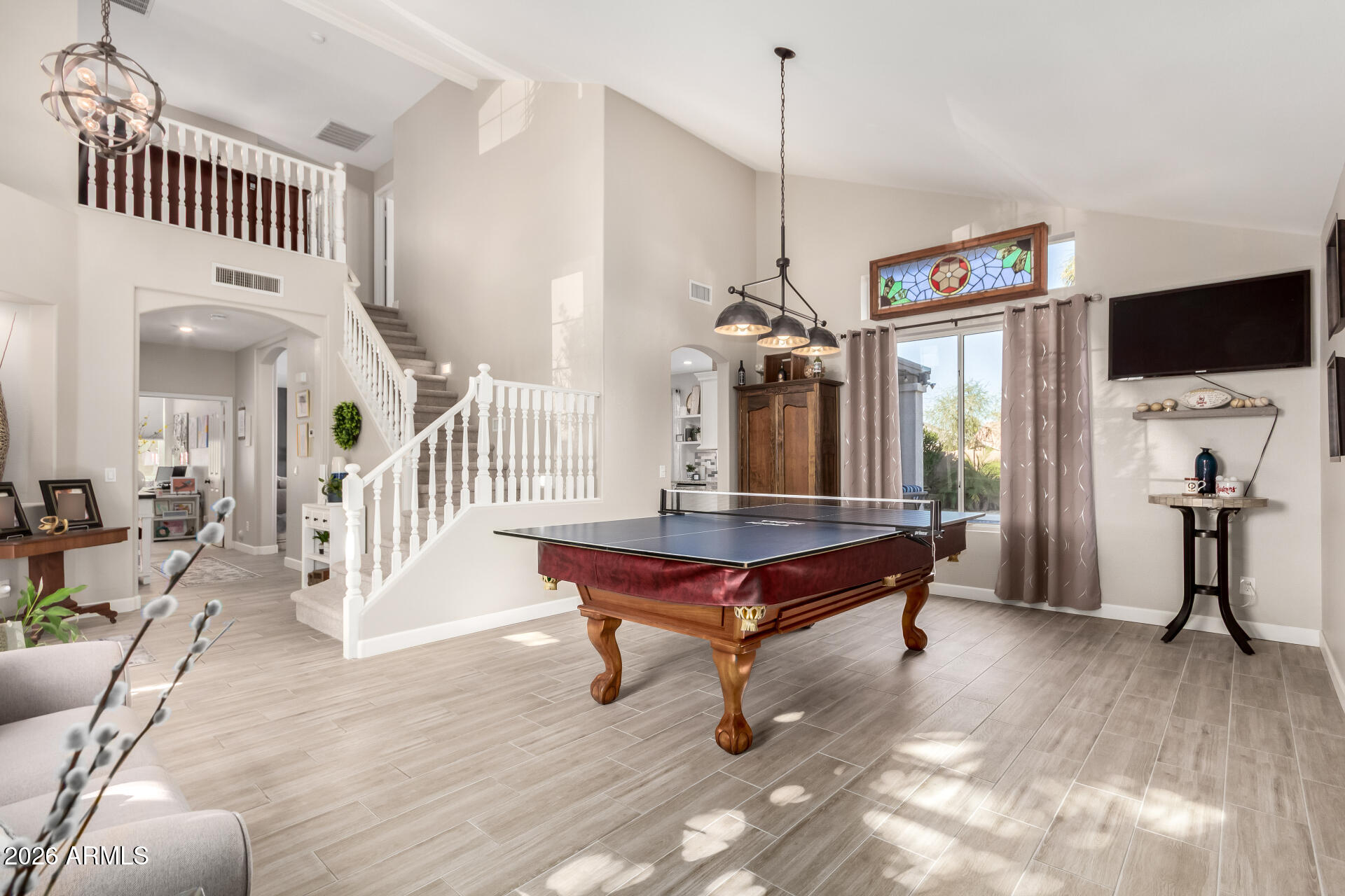 240 East Gail Court Gilbert, AZ 85296 - Photo 4 of 49 a living room with furniture a flat screen tv and a table