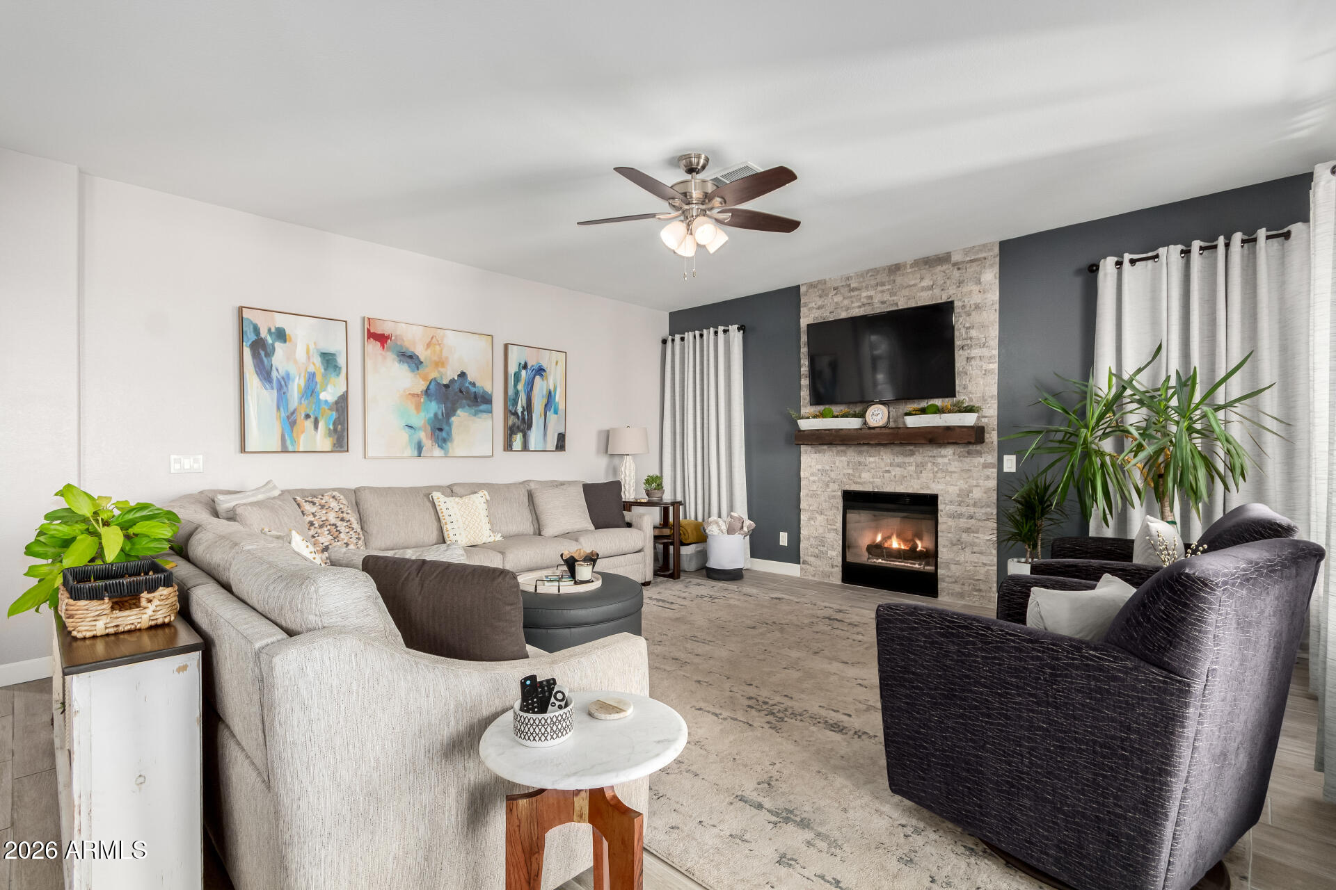 240 East Gail Court Gilbert, AZ 85296 - Photo 7 of 49 a living room with furniture a fireplace and a flat screen tv