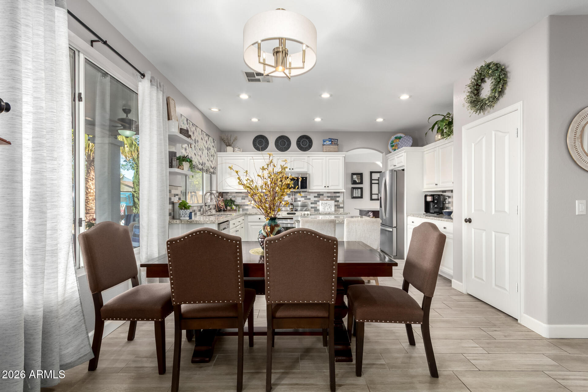 240 East Gail Court Gilbert, AZ 85296 - Photo 10 of 49 a dining room with furniture and a chandelier