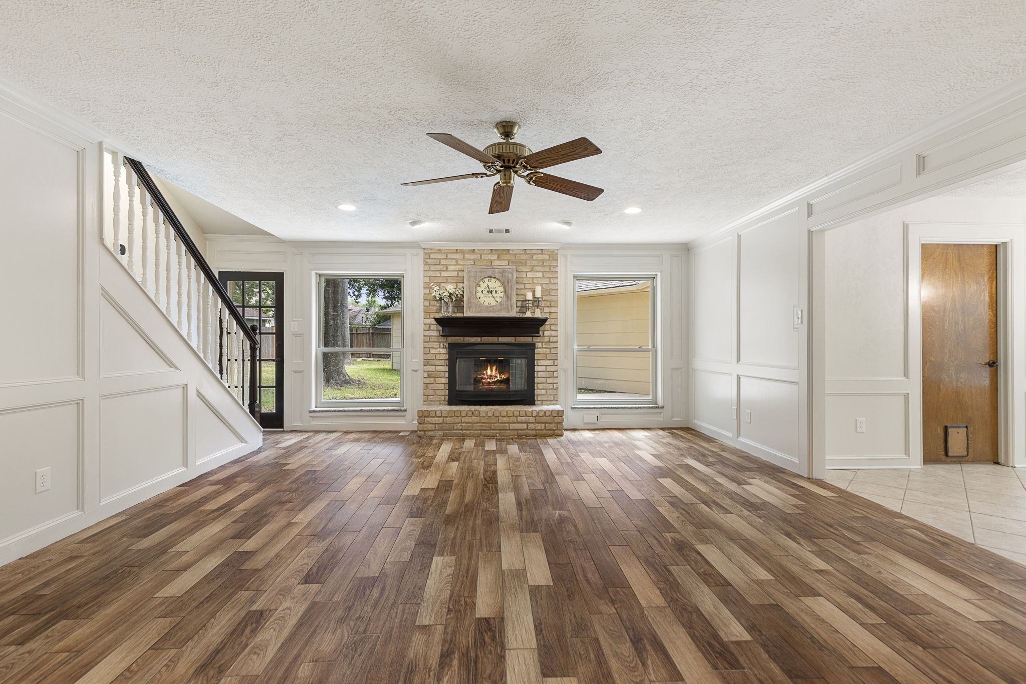 17706 Asphodel Lane Spring, TX 77379 - Photo 19 of 48 a view of an empty room with wooden floor fireplace and a window