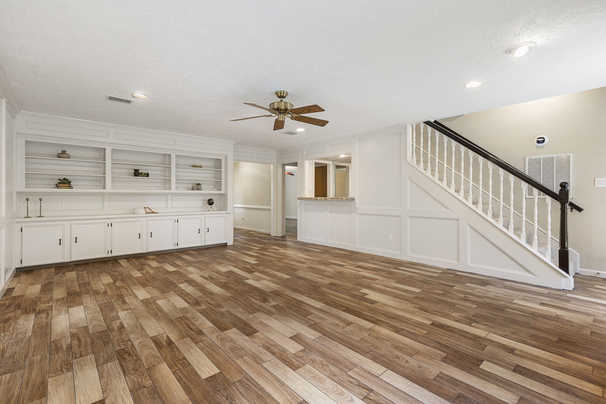 17706 Asphodel Lane Spring, TX 77379 - Photo 21 of 48 a view of a livingroom with wooden floor and a ceiling fan