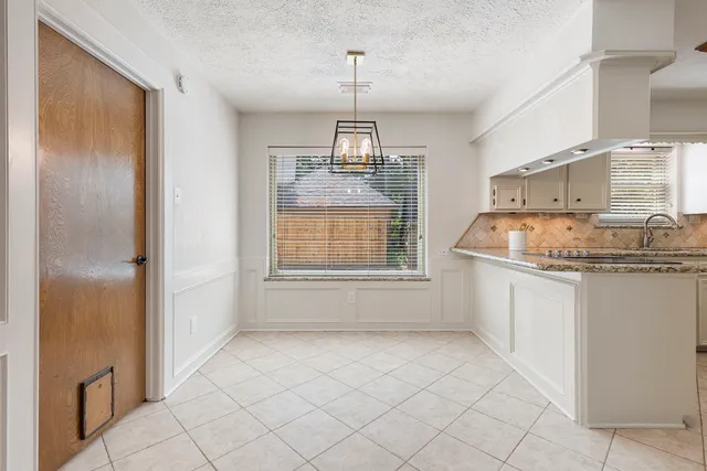 a view of a house with backyard and a tree