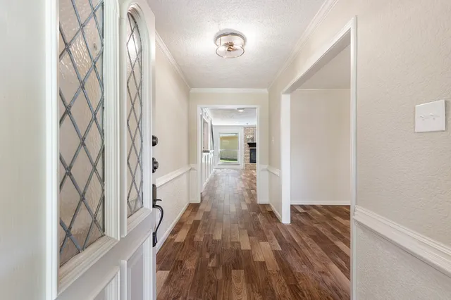 a view of a hallway with wooden floor