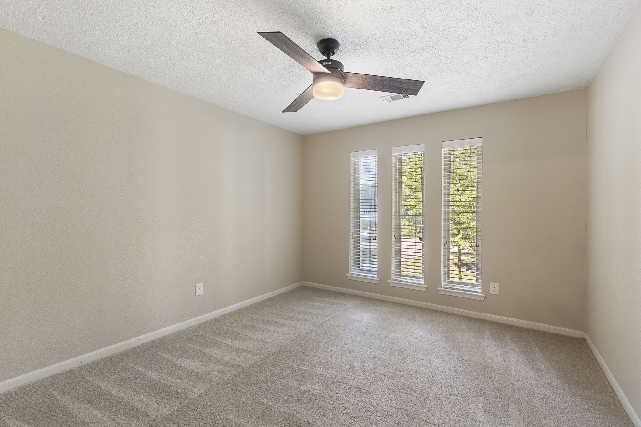 17706 Asphodel Lane Spring, TX 77379 - Photo 35 of 48 an empty room with windows and ceiling fan