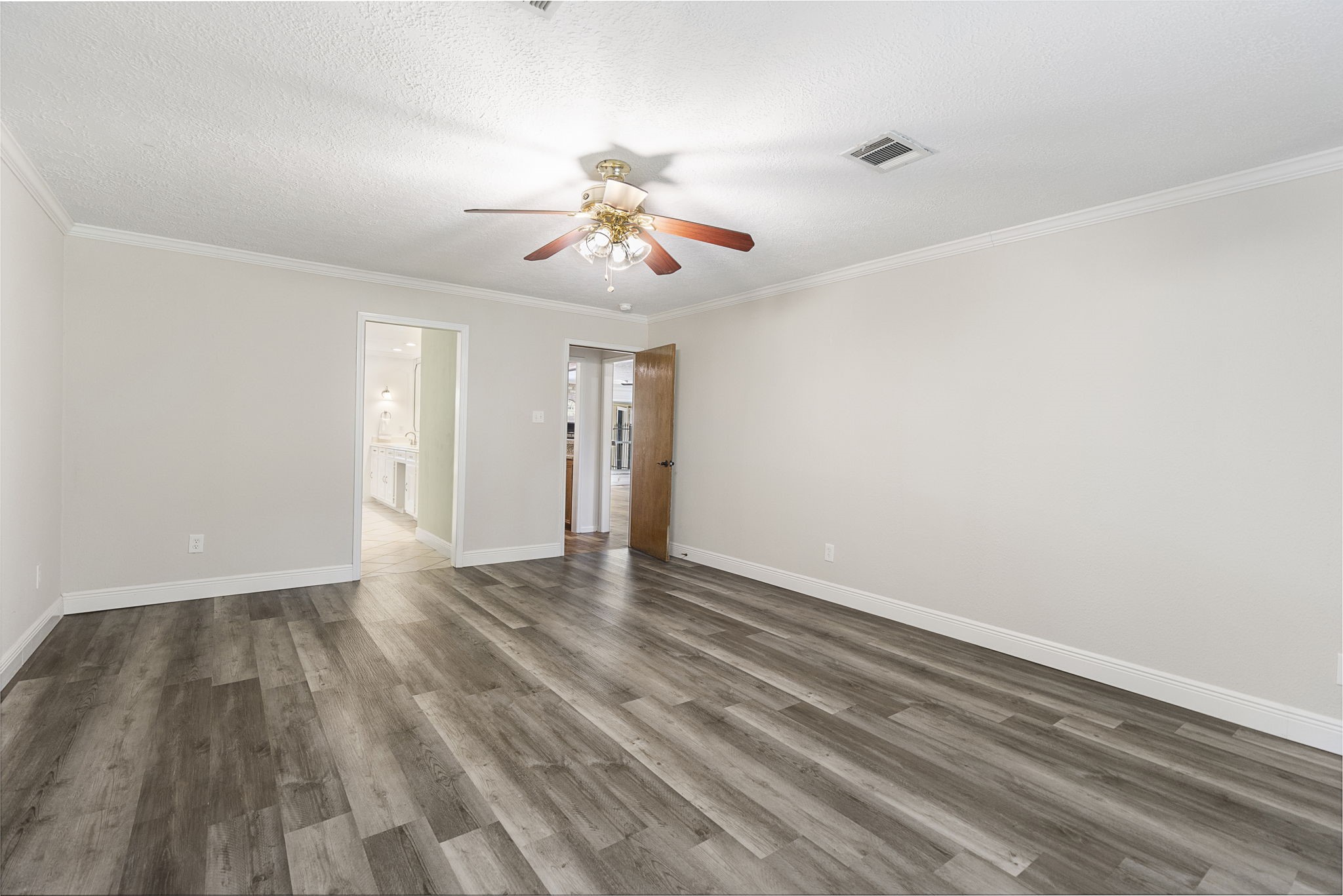 17706 Asphodel Lane Spring, TX 77379 - Photo 10 of 48 a view of an empty room with wooden floor and ceiling fan