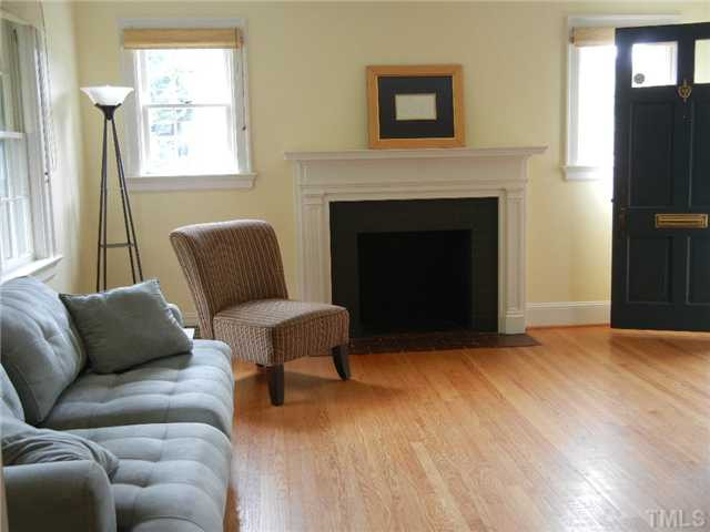 Living room with hardwoods, lots of windows and fireplace. Fireplace is non-functional (and is being sold "as is") however maybe you could install gas logs???