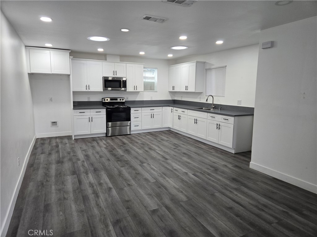 5327 Tyler Street, Unit A Riverside, CA 92503 - Photo 2 of 8 a large kitchen with stainless steel appliances granite countertop a stove a sink and a refrigerator