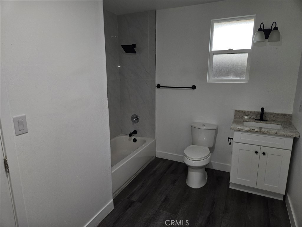 5327 Tyler Street, Unit A Riverside, CA 92503 - Photo 8 of 8 a bathroom with a granite countertop toilet a sink and a bathtub