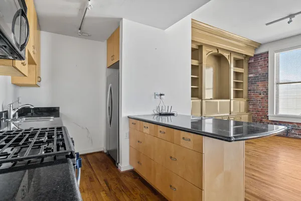 a kitchen with sink a stove and cabinets