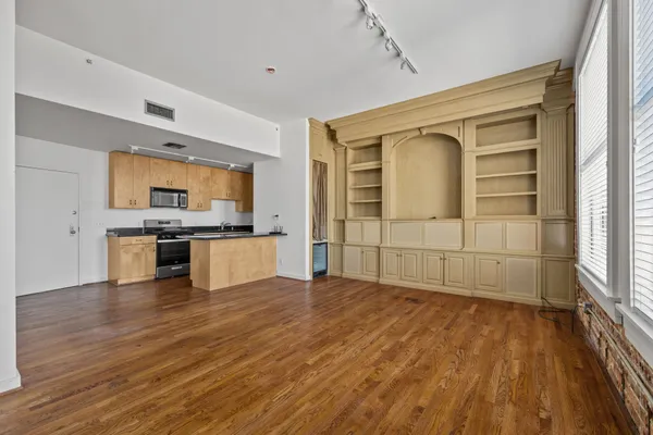 a view of kitchen with granite countertop cabinets and wooden floor