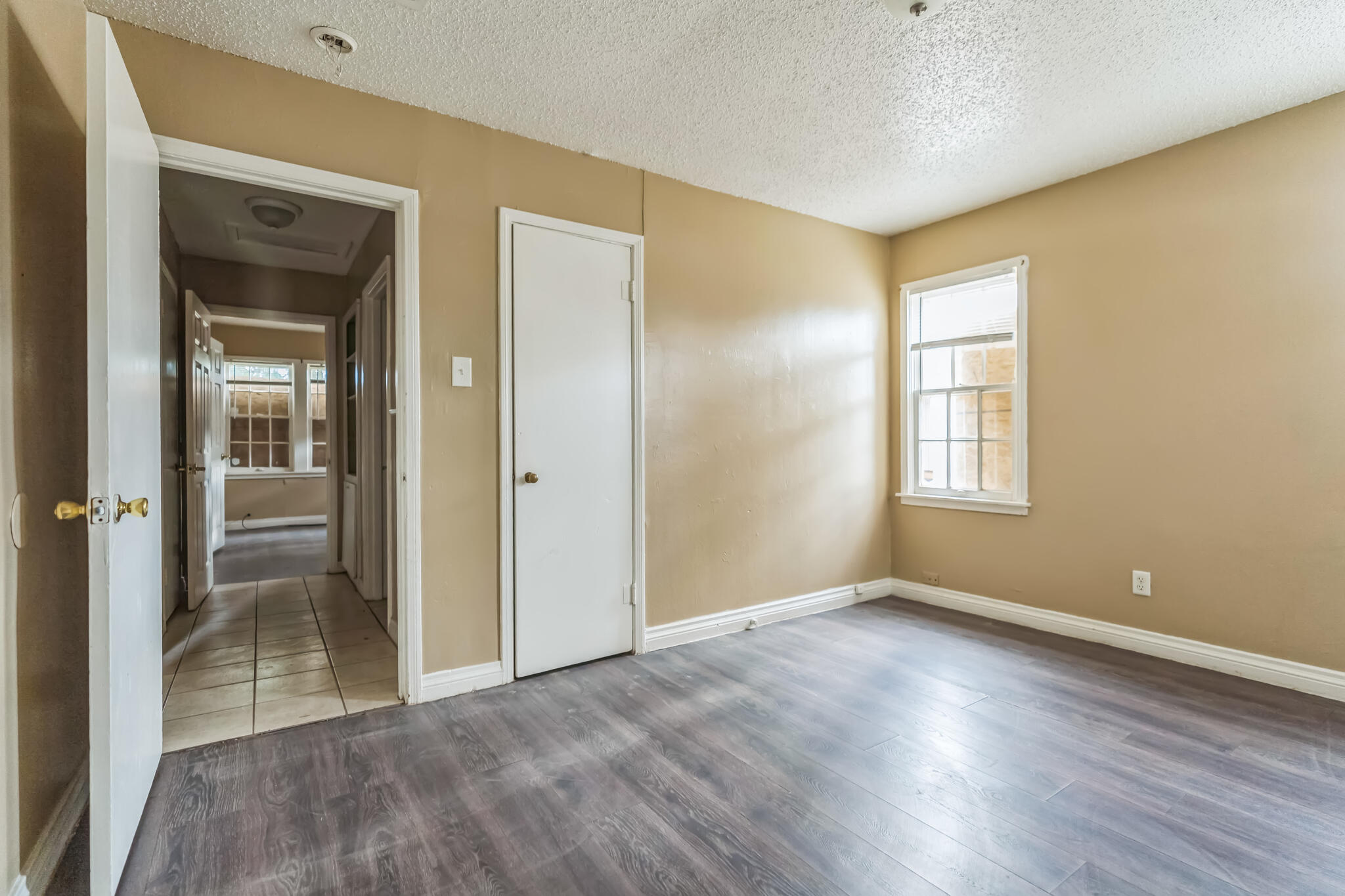 1510 33rd Street Lubbock, TX 79411 - Photo 11 of 33 a view of empty room with wooden floor and fan