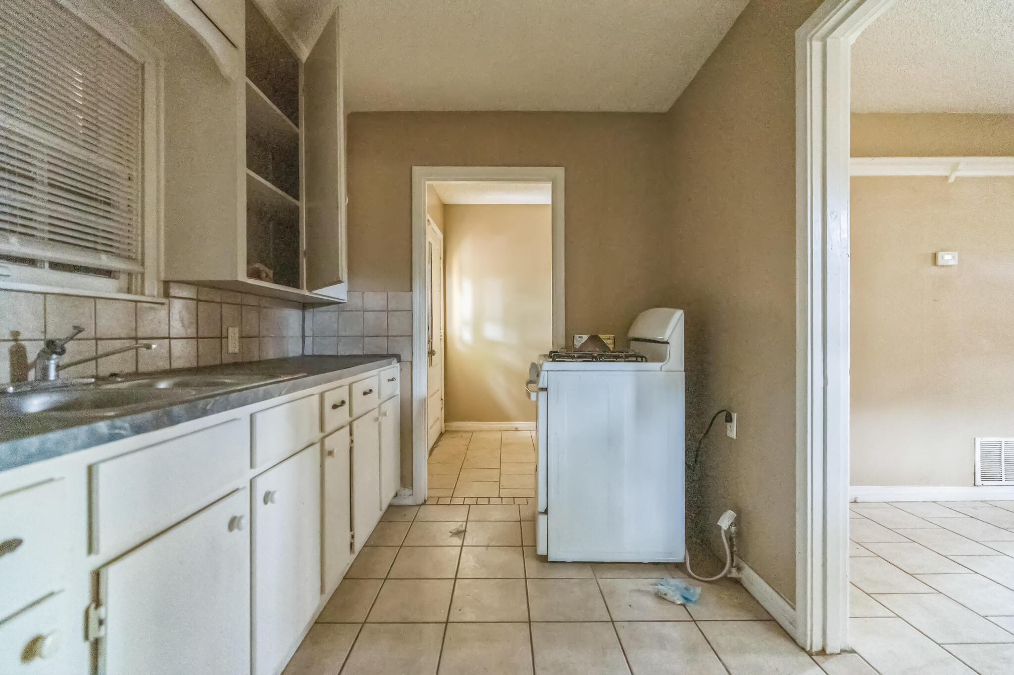 1510 33rd Street Lubbock, TX 79411 - Photo 18 of 33 a bathroom with granite countertop a sink and a mirror